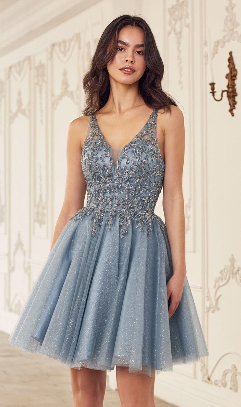 A woman stands indoors wearing the Lace-Up Short A-Line Homecoming Dress CY022, featuring a fitted beaded bodice and flared light blue tulle skirt.
